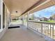 Spacious front porch with elegant columns and a view of the landscaped yard at 12300 Caldwell Rd, Charlotte, NC 28213