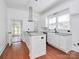 Modern kitchen boasts stainless appliances, island, granite countertops, and lots of natural light at 12300 Caldwell Rd, Charlotte, NC 28213