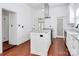 Kitchen with stainless appliances and white cabinets, bright modern lighting and open floor plan at 12300 Caldwell Rd, Charlotte, NC 28213