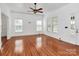 Spacious living area features refinished hardwood floors, natural light, and neutral paint at 12300 Caldwell Rd, Charlotte, NC 28213