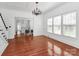Bright living room with hardwood floors, large windows, and a decorative chandelier at 12300 Caldwell Rd, Charlotte, NC 28213