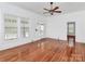 Bright living room with hardwood floors, large windows, and neutral walls at 12300 Caldwell Rd, Charlotte, NC 28213