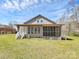 View of rear exterior with porch, yard, and a neighbor's house in the distance at 12300 Caldwell Rd, Charlotte, NC 28213