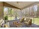 Staged sunroom with furniture, lots of windows, a ceiling fan, and views of the backyard at 12300 Caldwell Rd, Charlotte, NC 28213