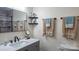 Modern bathroom with a stylish vanity, decorative mirror, and elegant towel racks at 1327 Mount Ulla Hwy, Mooresville, NC 28115