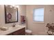 Bathroom featuring modern sink with ample counter space and a window at 1327 Mount Ulla Hwy, Mooresville, NC 28115
