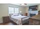 Bedroom features natural light, hardwood floors, and a decorative fireplace at 1327 Mount Ulla Hwy, Mooresville, NC 28115