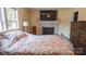 Bedroom features natural light, hardwood floors, and a decorative fireplace at 1327 Mount Ulla Hwy, Mooresville, NC 28115