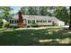 Charming one-story home with brick chimney and manicured front yard in a peaceful, wooded setting at 1327 Mount Ulla Hwy, Mooresville, NC 28115