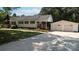 Traditional-style home with detached two-car garage, complemented by a concrete driveway and lush greenery at 1327 Mount Ulla Hwy, Mooresville, NC 28115
