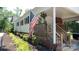 Home entrance with American flag, lovely landscaping, and brick accents, adding character and charm at 1327 Mount Ulla Hwy, Mooresville, NC 28115