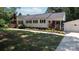 Well-manicured lawn and garden beds highlight this quaint white home and detached two-car garage at 1327 Mount Ulla Hwy, Mooresville, NC 28115