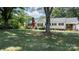 Beautiful front lawn view of a white house with a red brick chimney at 1327 Mount Ulla Hwy, Mooresville, NC 28115
