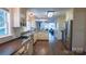 Bright, updated kitchen with stainless steel appliances and hardwood floors, seamlessly connecting to living spaces at 1327 Mount Ulla Hwy, Mooresville, NC 28115