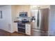 Modern kitchen featuring stainless steel refrigerator, oven, and microwave, creating a sleek and efficient workspace at 1327 Mount Ulla Hwy, Mooresville, NC 28115