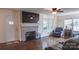Living room featuring a brick fireplace, hardwood floors, and natural light at 1327 Mount Ulla Hwy, Mooresville, NC 28115