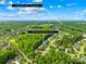 Aerial view of a neighborhood surrounded by lush trees with home address identified at 136 Pink Orchard Dr, Mooresville, NC 28115