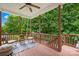 Inviting back porch with wooded views, comfortable seating, ceiling fan, and painted wood flooring at 136 Pink Orchard Dr, Mooresville, NC 28115
