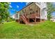 Back exterior view of a home featuring the deck, yard, and landscaping at 136 Pink Orchard Dr, Mooresville, NC 28115