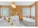 A well lit bathroom featuring double sinks, a soaking tub, and windows that provide plenty of natural light at 136 Pink Orchard Dr, Mooresville, NC 28115