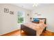 Serene bedroom featuring a comfortable bed, natural light from a window, and warm hardwood floors at 136 Pink Orchard Dr, Mooresville, NC 28115