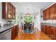 Well-lit dining area with cherry cabinets, a garden view, and a modern light fixture at 136 Pink Orchard Dr, Mooresville, NC 28115