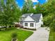 Charming two-story home with lush landscaping and a private driveway at 136 Pink Orchard Dr, Mooresville, NC 28115