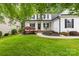 Inviting two-story home with a lush front yard and landscaped garden beds at 136 Pink Orchard Dr, Mooresville, NC 28115