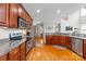 Stylish kitchen featuring stainless steel appliances, granite countertops, and hardwood floors at 136 Pink Orchard Dr, Mooresville, NC 28115