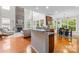 Bright living room with a stone fireplace open to the kitchen and dining area at 136 Pink Orchard Dr, Mooresville, NC 28115