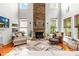 Bright living room with a floor-to-ceiling stone fireplace and large windows at 136 Pink Orchard Dr, Mooresville, NC 28115