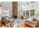 Bright living room with a stone fireplace, soaring ceilings, and many large windows at 136 Pink Orchard Dr, Mooresville, NC 28115