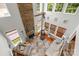 Living room featuring a stone fireplace, large windows, and comfortable seating arrangements at 136 Pink Orchard Dr, Mooresville, NC 28115