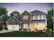 Charming two-story brick home with a well-manicured lawn and an attached two-car garage at 13904 Penbury Ln # 393, Charlotte, NC 28278