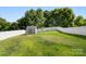 Lush backyard featuring a storage shed and a pristine white fence, perfect for outdoor enjoyment at 1398 Kent Downs Sw Ave # 52, Concord, NC 28027