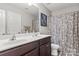 Bathroom featuring a double sink vanity with a shower and toilet in a separate adjacent stall with a curtain at 1398 Kent Downs Sw Ave # 52, Concord, NC 28027