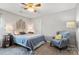 Inviting bedroom with a cozy armchair, bedside lamps, and a soft area rug, enhancing the room's comfort and style at 1398 Kent Downs Sw Ave # 52, Concord, NC 28027