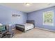 Well-lit bedroom with a cozy twin bed, neutral carpet, and matching furniture at 1398 Kent Downs Sw Ave # 52, Concord, NC 28027