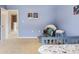 Bright bedroom featuring light-blue walls, neutral carpet, and decoratively adorned with space-themed art at 1398 Kent Downs Sw Ave # 52, Concord, NC 28027