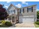 Charming two-story home with neutral siding, a welcoming porch, and an attached two-car garage at 1398 Kent Downs Sw Ave # 52, Concord, NC 28027