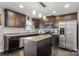 Modern kitchen with dark cabinetry, stainless steel appliances, granite countertops, and a central island at 1398 Kent Downs Sw Ave # 52, Concord, NC 28027