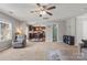 Spacious living room with a ceiling fan, natural light, and seamless access to the kitchen area at 1398 Kent Downs Sw Ave # 52, Concord, NC 28027