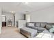 Comfortable living room with gray sofa, ottoman, carpet floors, and neutral walls, creating a cozy and inviting space at 1398 Kent Downs Sw Ave # 52, Concord, NC 28027