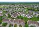This aerial view shows houses with well maintained lawns and mature trees in a residential neighborhood at 1418 Skidaway Nw St # 427, Concord, NC 28027