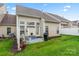 A backyard features a patio with seating and a grill, with nice yard space at 1418 Skidaway Nw St # 427, Concord, NC 28027