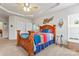 Bright bedroom featuring a decorative ceiling, ceiling fan, and a large bed with colorful linens at 1418 Skidaway Nw St # 427, Concord, NC 28027