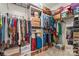 Walk-in closet with shelving and hanging storage filled with clothes and personal items at 1418 Skidaway Nw St # 427, Concord, NC 28027