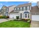 Daytime view of a two-story home with a two-car garage, landscaped front yard, and inviting curb appeal at 1418 Skidaway Nw St # 427, Concord, NC 28027