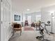 Bright flex space with exercise equipment and multiple seating options at 1418 Skidaway Nw St # 427, Concord, NC 28027