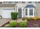 Inviting front entrance featuring a well-maintained lawn, lush landscaping, and a charming front door at 1418 Skidaway Nw St # 427, Concord, NC 28027
